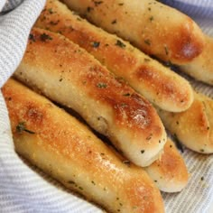 some bread sticks are on a white plate