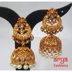 Golden Triple Jhumka Earring with golden beads Premium Quality Kundan Jhumka Earrings Length: Approx. 2.65" Light-weight Push-Back closure Gold Finish on high-quality brass as the base metal, Kundan stones and Pearls Suitable for any traditional or contemporary attire and occasion In-stock & ready-to-ship **Color may vary slightly due to photography and lighting. Brass Chandbali Jhumkas With Intricate Design, Brass Temple Jewelry Bridal Earrings With Latkans, Heavy Bollywood Brass Bridal Earrings, Heavy Brass Bollywood Bridal Earrings, Bollywood Style Heavy Brass Bridal Earrings, Temple Style Bridal Brass Earrings For Festivals, Gold Plated Jhumkas With Latkans For Festivals, Bollywood Brass Jhumkas With Intricate Design, Bollywood Brass Chandbali Jhumkas