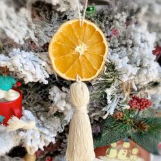 an orange ornament hanging from a christmas tree