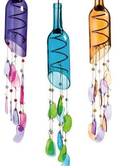 three colorful glass bottles hanging from strings