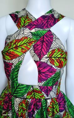 This handmade women's dress features a beautiful colorblock African print in multicolor polyester. The dress has a halter neckline, sleeveless design, and a zipper closure. It comes in size M, L and XL and is perfect for weddings, parties, casual or workwear occasions.  The dress is made with woven fabric and has a fit & flare, shift, maxi style. It has an empire waist, cut out, keyhole neck, and high waist features. Ideal for summer, fall, or spring, this dress is a must-have for any beach-them Fitted Multicolor Sleeveless Dress With Halter Neck, Fitted Multicolor Sleeveless Halter Neck Dress, Multicolor Fitted Sleeveless Halter Neck Dress, Fitted Multicolor Printed Halter Dress, Multicolor Sleeveless Dress With Bold Print, Multicolor Tropical Print Halter Neck Dress, Multicolor Floral Print Halter Neck Sleeveless Dress, Green Floral Print Halter Neck Sleeveless Dress, Multicolor Halter Neck Dress With Tropical Print