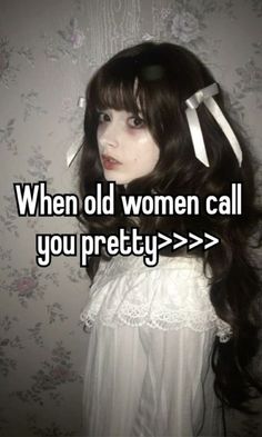 a woman with long black hair wearing a white dress and bow in her hair, the words'when old women call you pretty > > > > >