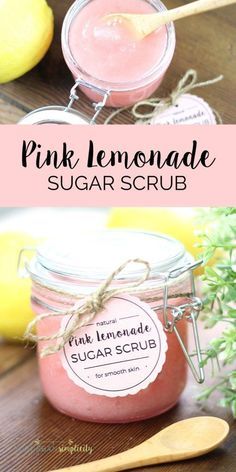 pink lemonade sugar scrub in a glass jar with a wooden spoon next to it