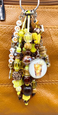 a brown purse with a bunch of charms attached to it