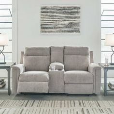 a living room scene with focus on the reclining sofa