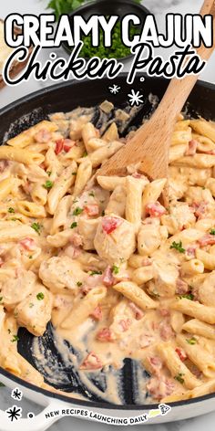 creamy cajun chicken pasta in a skillet with a wooden spoon