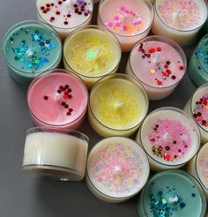 there are many candles that have sprinkles on them and one candle in the middle