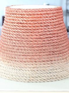 an orange and white vase sitting on top of a table