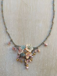 Vintage Colleen Toland Peach Apricot and Moss Green Petite Floral Necklace.  This lovely necklace is made by hand-painting resin flowers and beading them in an arrangement with tiny glass seed beads. The necklace itself is made with wired seed beads that are linked together. The finishing touch includes rare vintage glass beads in a pink barrel shape. It features a lobster claw closure and a 4-inch extender, allowing the length to be adjusted . The works shown are the last pieces from Colleen's Vintage Flower-shaped Beaded Necklaces, Vintage Green Multi-strand Beaded Necklaces, Green Vintage Hand-strung Beaded Necklaces, Vintage Green Multi-strand Necklace, Luxury Flower-shaped Beaded Necklaces, Romantic Jewellery, Floral Vintage, Floral Necklace, Resin Flowers