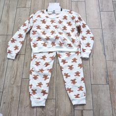 You Can't Catch Me, I'm The Gingerbread Man! Nwt 2 Piece Winter Christmas Holiday Gingerbread Man Jogger Pajama Pj Lounge Set In White With Randomly Placed Images Of Gingerbread Men, Size Medium The Set Is A Cozy Sweatshirt Material With A Brushed Fleece Interior Top Is Long Sleeved With Crew Neck Neckline And Is Cropped Stretchy Ribbed Material At Neck, Wrists, Ankles, And Bottom Hem For A Comfortable Fit Bottoms Have An Elastic Waist With Working Drawstring 2 In Seam Pockets 100 Percent Polyes Holiday White Sleepwear For Pajama Party, White Christmas Sleepover Sets, Cozy White Sleepover Sets, Casual White Christmas Sets, White Holiday Sets For Pajama Party, White Sets For Pajama Party In Winter, White Long Sleeve Sets For Holiday, White Christmas Sleepwear For Pajama Party, White Pajama Party Set For Winter