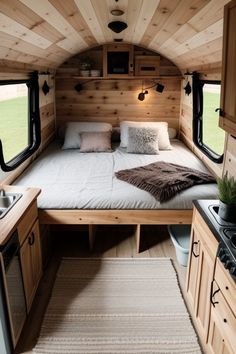 a bed sitting inside of a bedroom next to a sink and stove top oven in a room