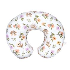 the neck pillow has flowers on it and is white with pink, yellow and green leaves