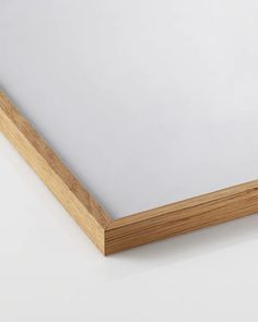 a close up of a wooden frame on a white surface