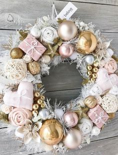 a wreath with pink and gold ornaments on it