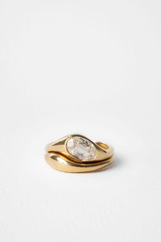 a gold ring with a white diamond in the middle