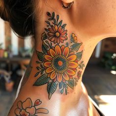 a woman with a flower tattoo on her neck