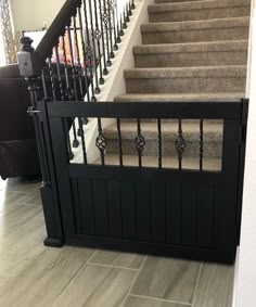 a stair case with wrought iron railing and handrail