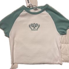 White Embroidered Crew Neck Top, White Crew Neck Top With Embroidered Graphics, Casual Green Tops With Embroidered Logo, Green Cotton Tops With Embroidered Logo, Green Cotton Top With Embroidered Logo, White Embroidered Graphic Tee, White Tops With Embroidered Logo For Spring, Sporty Spring Tops With Embroidered Logo, White T-shirt With Embroidered Logo For Spring