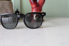 "5 1/2\"total width 2\"lens width 5.5\"arms length 1980s black sunnies these are so nice! metal hinges- sturdy and awesome 100% UV protection good condition/ priced as is love super retro! the perfect clubmasters! Thank YOU and please feel free to ask me any ?s:) Have a lovely day!! xoxo www.etsy.com/shop/retroandme #K" Vintage Black Sunglasses For Beach, Vintage Black Aviator Sunglasses For Summer, Vintage Black Beach Sunglasses, Black Vintage Aviator Sunglasses For Summer, Retro Plastic Festival Sunglasses, Vintage Black Plastic Sunglasses, Vintage Sunglasses With Gradient Lenses And Adjustable Fit, Retro Black Aviator Sunglasses For Beach, Vintage Cat Eye Sunglasses With Anti-reflective Coating