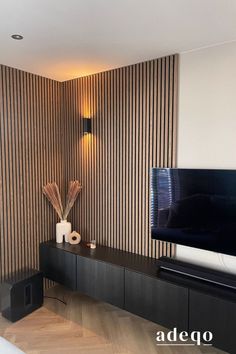 a flat screen tv sitting on top of a wooden entertainment center in a living room