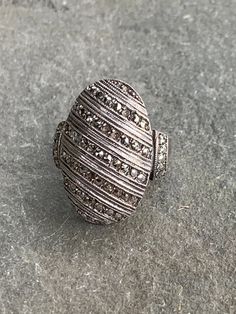 Marcasite ring with sterling silver that is all about sparkle! Really pretty oval design with slanted rows of marcasite and also marcasites on the sides - 6 stones are missing as it was a much loved piece - pictures show details but I don't feel that it is very obvious. Ring is a size 6 1/2 and very comfortable. Marcasite stones are faceted pyrite. There are makers marks stamped on the inside but it is not clear what they are. Vintage Oval Marcasite Rings, Vintage Marcasite Oval Rings, Silver Art Deco Jewelry With Pave Setting, Art Deco Silver Jewelry With Pave Setting, Silver Oval Diamond Ring With Stone Setting, Oval Silver Diamond Ring With Stone Setting, Vintage Silver Jewelry With Pave Setting, Silver Oval Ring With Pave Setting, Silver Oval Rings With Stones