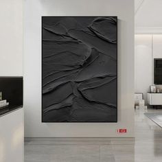 a black and white abstract painting on the wall