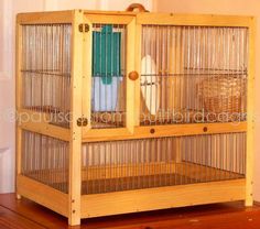 a wooden bird cage sitting on top of a hard wood floor