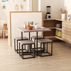 a kitchen table with four stools next to it on a hard wood flooring area