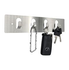 two keys are hanging from a metal hook on a key rack with chains attached to it