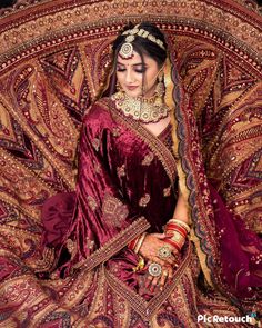 a woman in a red and gold bridal outfit