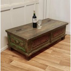 an old wooden table with a bottle of wine on top