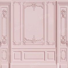 a pink room with ornate paneling and walls