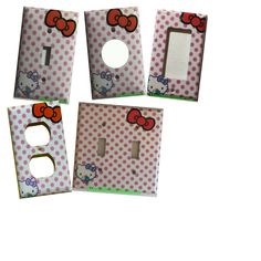 four hello kitty light switch covers with polka dots