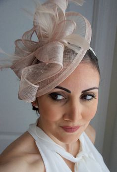 Penny Nude Fascinator Hat Headband Timeless glamour. This sassy fascinator gives a nod to vintage style with a bouncy mesh ribbon and flighty feathers. With its classic sinamay mesh shape and elegant look it will be your go-to fascinator for the season. - Light weight - Attached to Spring Fascinator Hat For Wedding Guest, Spring Wedding Guest Hat Fascinator, Elegant Adjustable Fascinator With Matching Headband, Elegant Headband For Kentucky Derby Wedding Guest, Elegant Kentucky Derby Fascinator With Matching Headband, Elegant Headband For Wedding Guest At Kentucky Derby, Elegant Fascinator For Wedding Guests, Spring Wedding Guest Fascinator Hat, Fitted Beige Mini Hat For Party