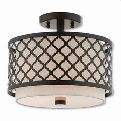 a semi flush light fixture with an intricate design on the drum and white fabric shade