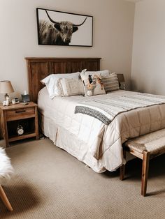 a bedroom with a bed, nightstands and pictures on the wall above it's headboard