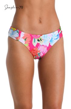 Drenched in vibrant energy, this hipster bottom by Sunshine 79 features a bold hot pink floral print that radiates an atmosphere of tropical exuberance. The vivid and lively floral pattern adds a pop of color and a sense of playful charm to your swimwear collection. At once sexy and sophisticated, these hipsters feature a high-cut front with hip-flattering shirring on each side. Just-right coverage in back keeps the look subtly seductive. [split] Details Hipster bikini bottom Hip-flattering side Vibrant Pink Floral Print Swimwear, Floral Print Stretch Bottoms For Pool, Stretch Floral Print Bottoms For Pool, Tropical Pink Swimwear With Vibrant Print, Pink Tropical Swimwear With Vibrant Print, Vibrant Floral Print Beach Bottoms, Spring Pink Swimwear With Vibrant Print, Vibrant Pink Printed Swimwear, Vibrant Fitted Poolside Bottoms