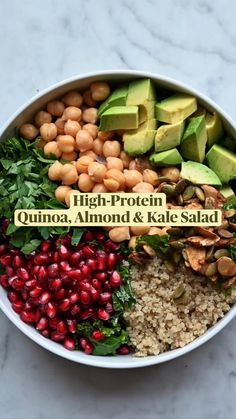 a bowl filled with quinoa, avocado, and kale salad