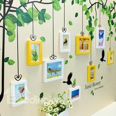 there are many pictures hanging on the wall with tree branches and birds in them,