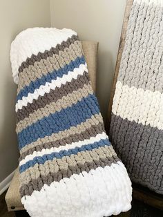 two blankets sitting next to each other on a chair