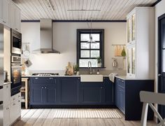 a kitchen with white walls and blue cabinets is pictured in this image from the inside