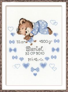 a cross stitch baby announcement with a teddy bear on it's back and hearts around the frame