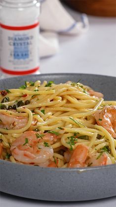 pasta with shrimp and parsley in a bowl