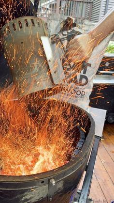 an iron pot is being used to make something orange and brown with sparks coming out of it