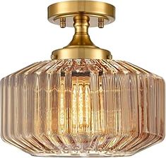 a light that is on top of a ceiling fixture with a glass bowl in the middle