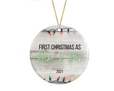 a first christmas as mr and mrs ornament hanging from a string of lights