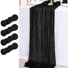 four skeins of black yarn sitting on top of a table next to a white sheet