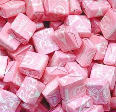 a pile of pink candy cubes sitting on top of each other