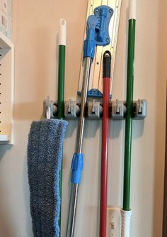 several cleaning tools are hanging on the wall