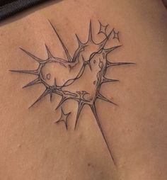 a tattoo on the back of a woman's stomach with thorns growing out of it